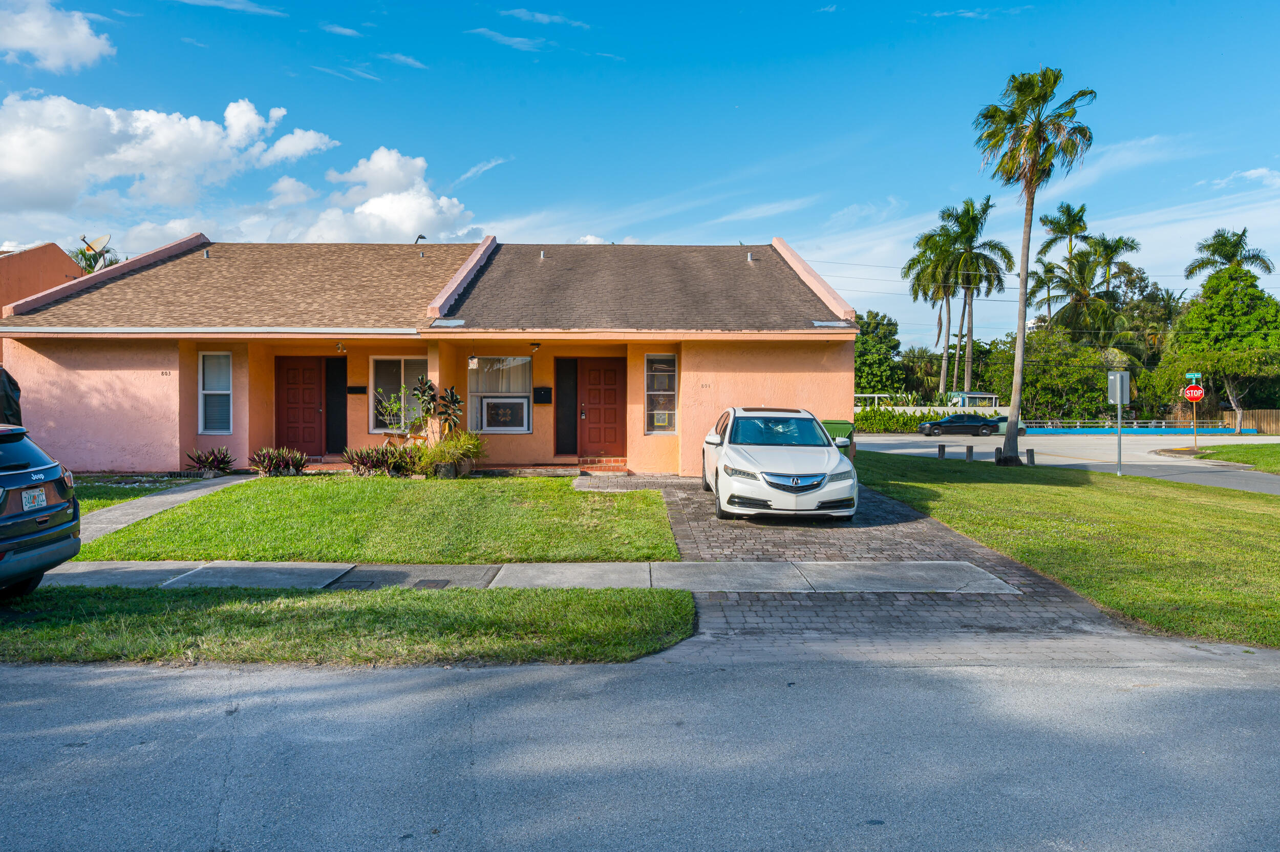 801 Southwest 12th Place Fort Lauderdale, FL 33315 - Photo 1 of 26 a car parked in front of a house next to a yard
