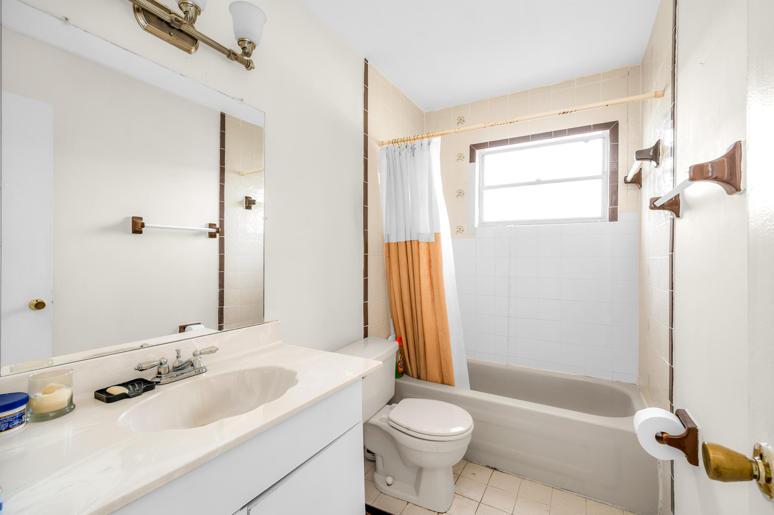 801 Southwest 12th Place Fort Lauderdale, FL 33315 - Photo 10 of 26 a bathroom with a double vanity sink toilet mirror and shower