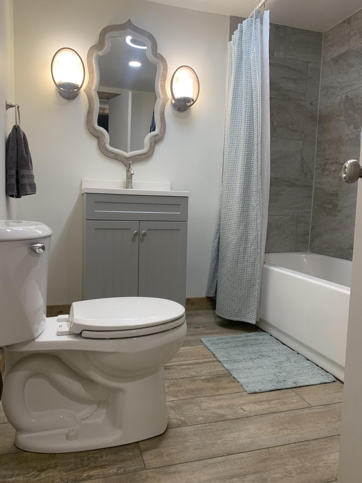 211 Reed Avenue Whitharral, TX 79336 - Photo 12 of 20 a bathroom with a toilet and a mirror