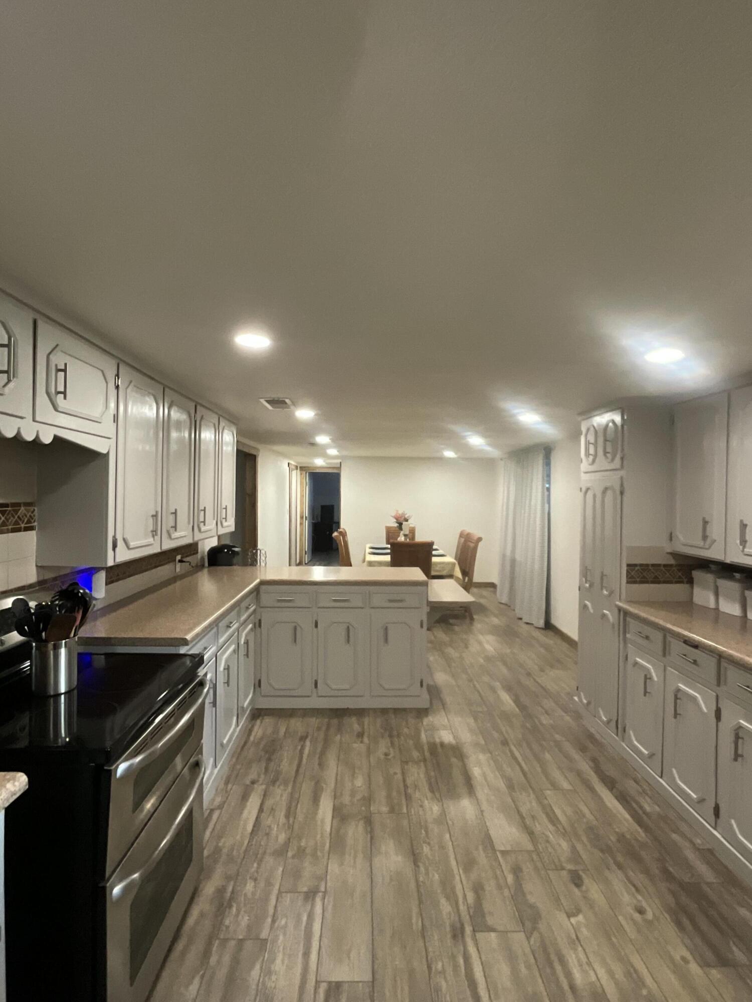 211 Reed Avenue Whitharral, TX 79336 - Photo 13 of 20 a large kitchen with a lot of counter space and stainless steel appliances