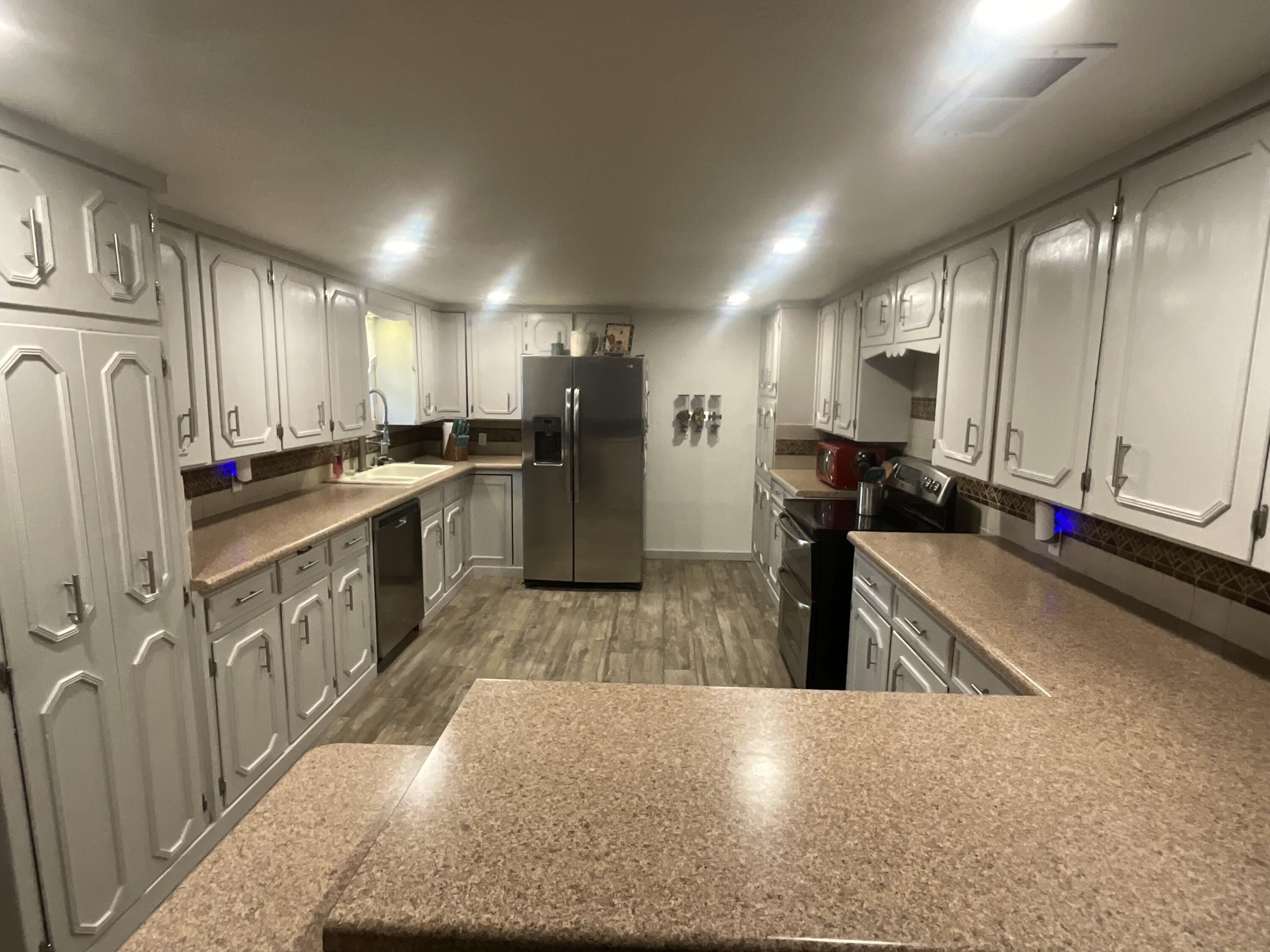 211 Reed Avenue Whitharral, TX 79336 - Photo 14 of 20 a kitchen with stainless steel appliances granite countertop a refrigerator a stove and a sink