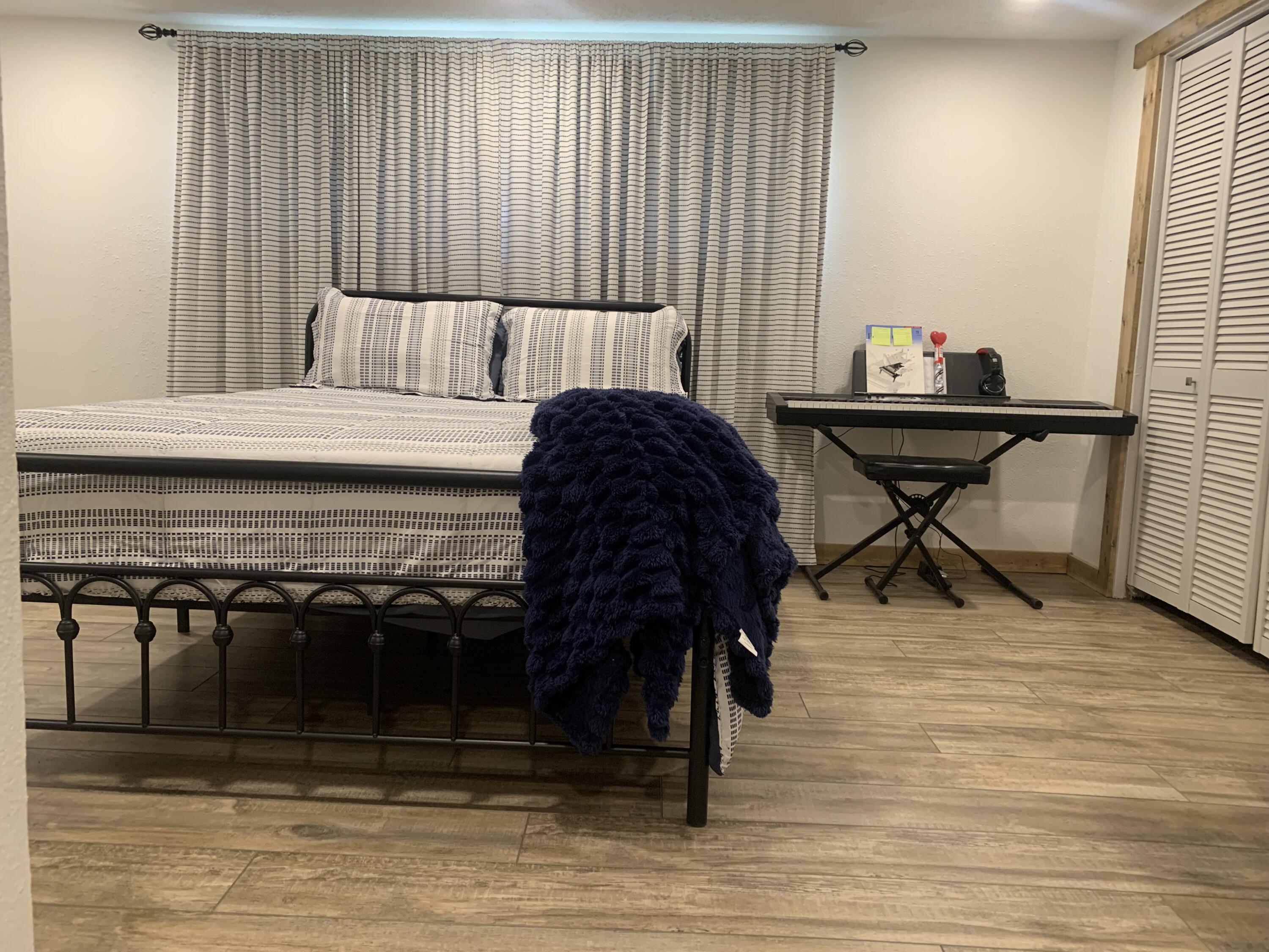 211 Reed Avenue Whitharral, TX 79336 - Photo 15 of 20 a bedroom with a bed and a table in it
