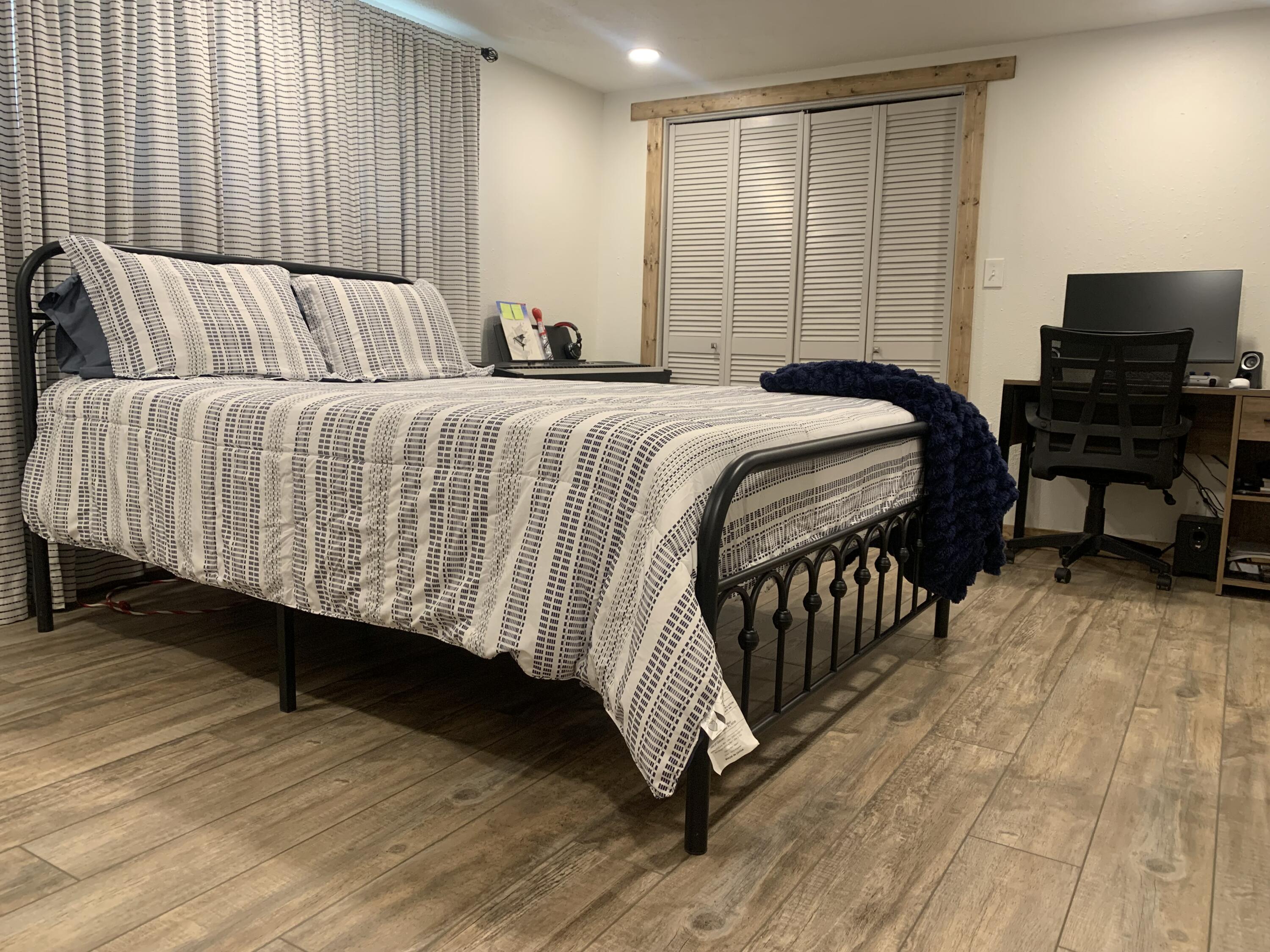 211 Reed Avenue Whitharral, TX 79336 - Photo 16 of 20 a bedroom with a bed and wooden floor
