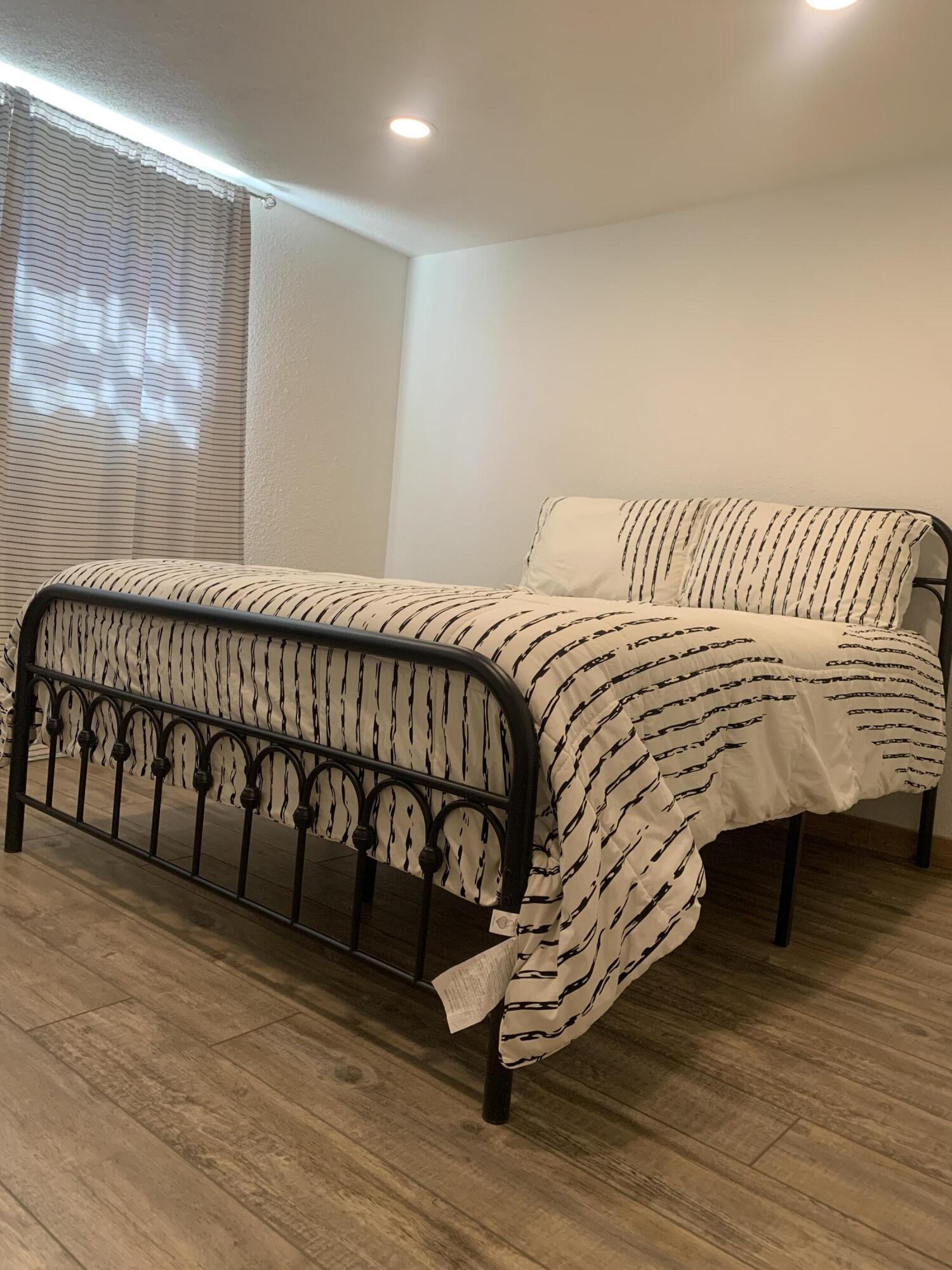 211 Reed Avenue Whitharral, TX 79336 - Photo 18 of 20 a bedroom with a bed and a window