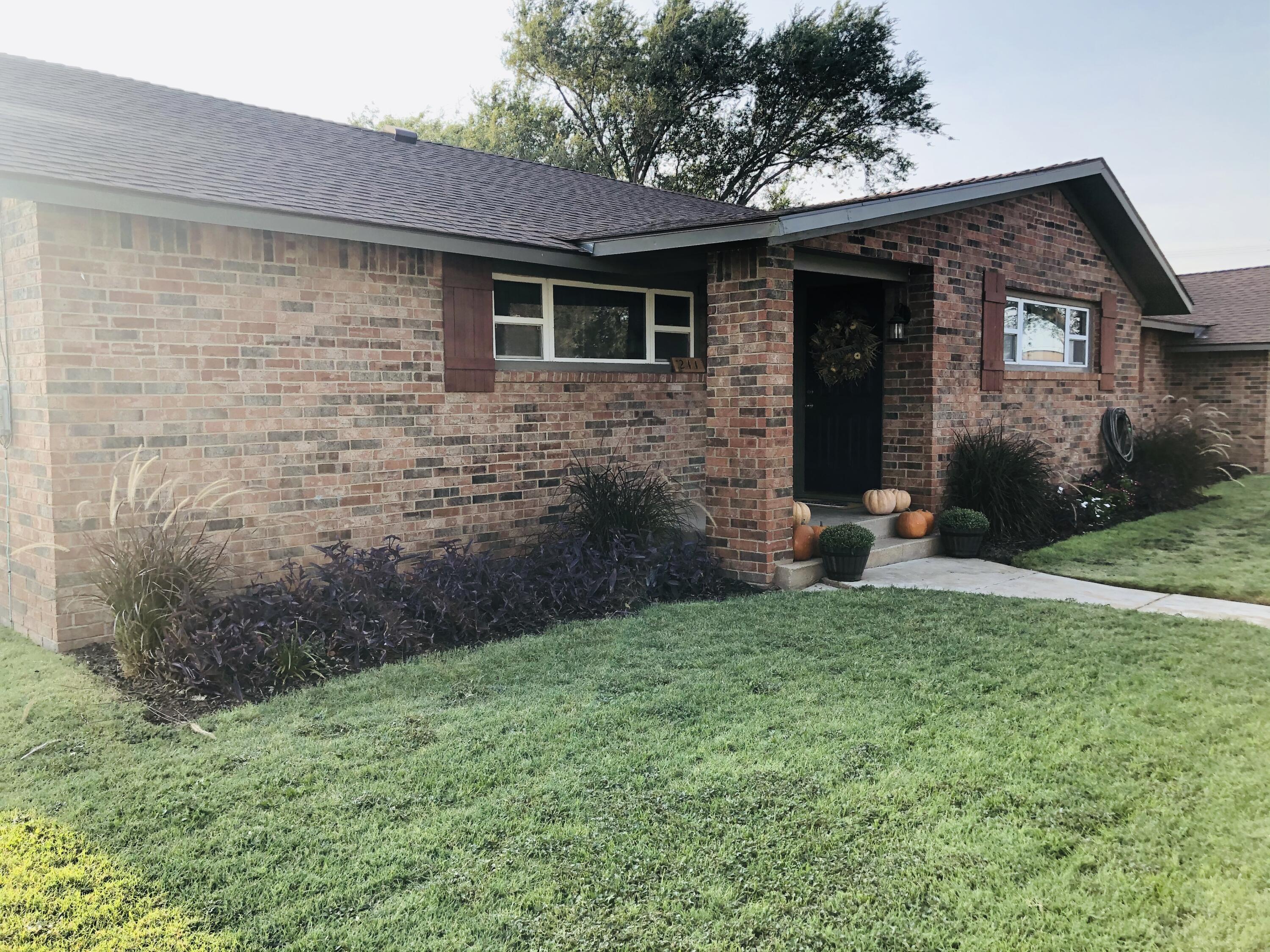 211 Reed Avenue Whitharral, TX 79336 - Photo 2 of 20 a front view of a house with garden