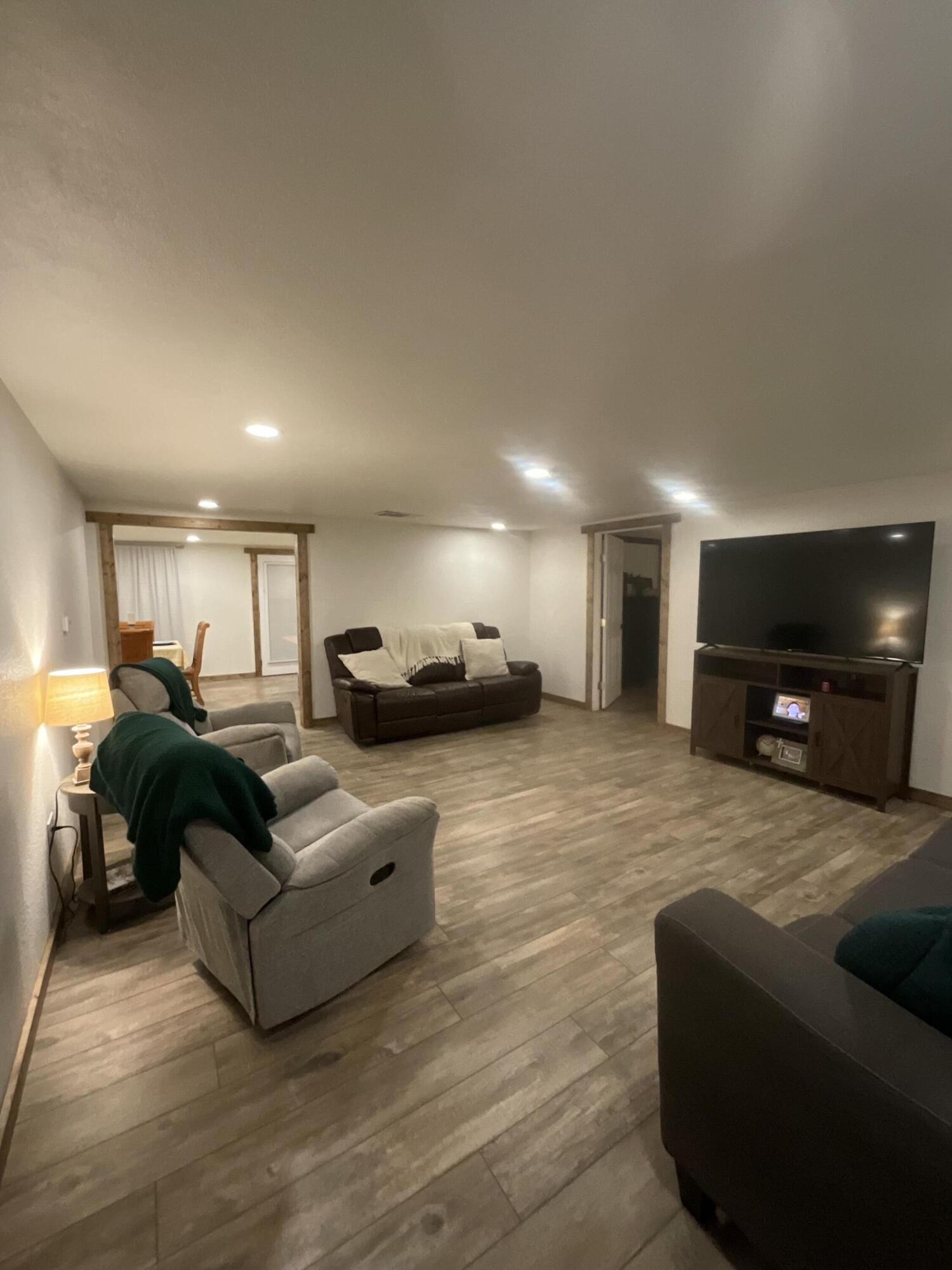 211 Reed Avenue Whitharral, TX 79336 - Photo 5 of 20 a living room with furniture and a flat screen tv