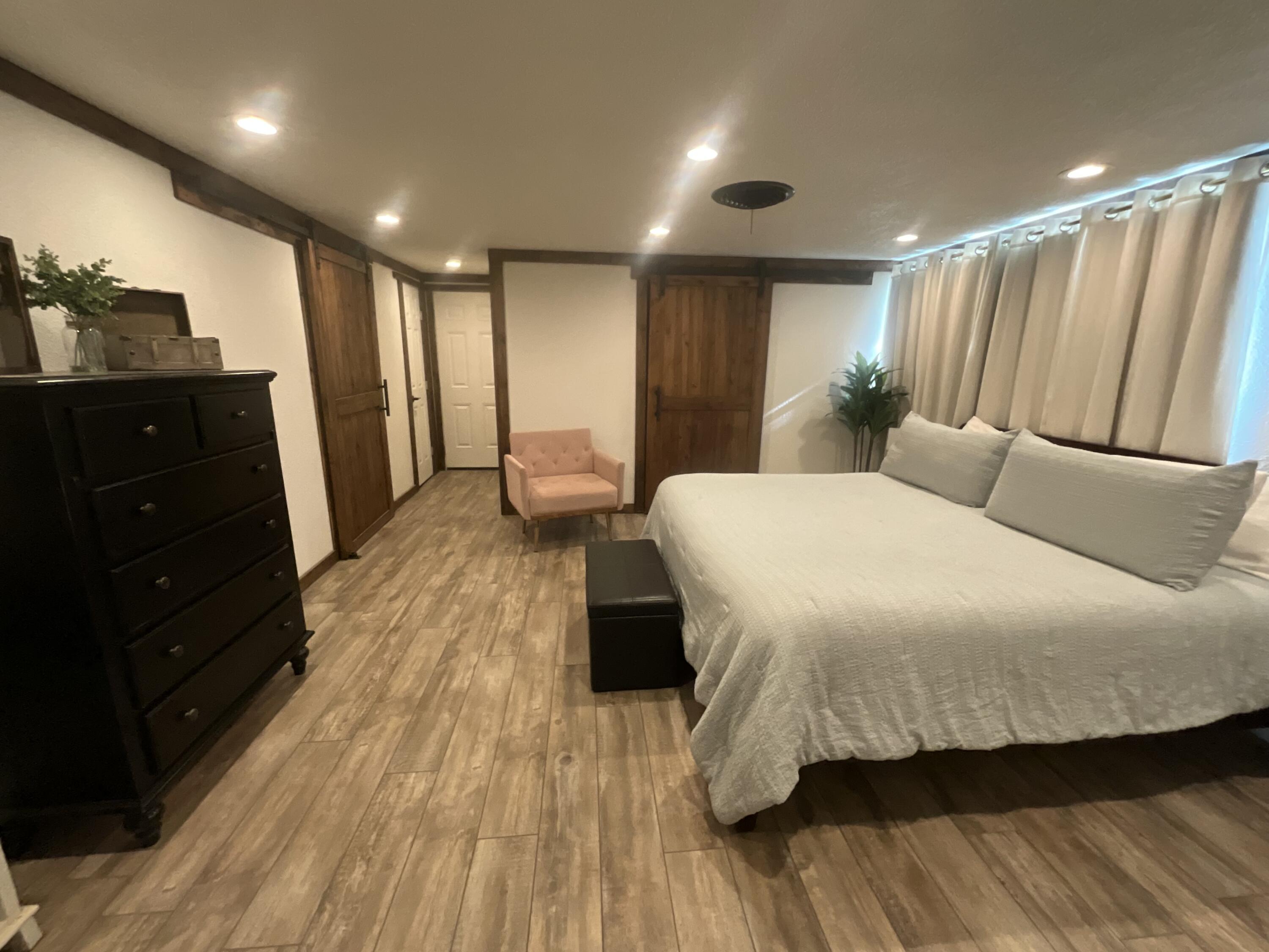 211 Reed Avenue Whitharral, TX 79336 - Photo 6 of 20 a spacious bedroom with a bed and a dresser