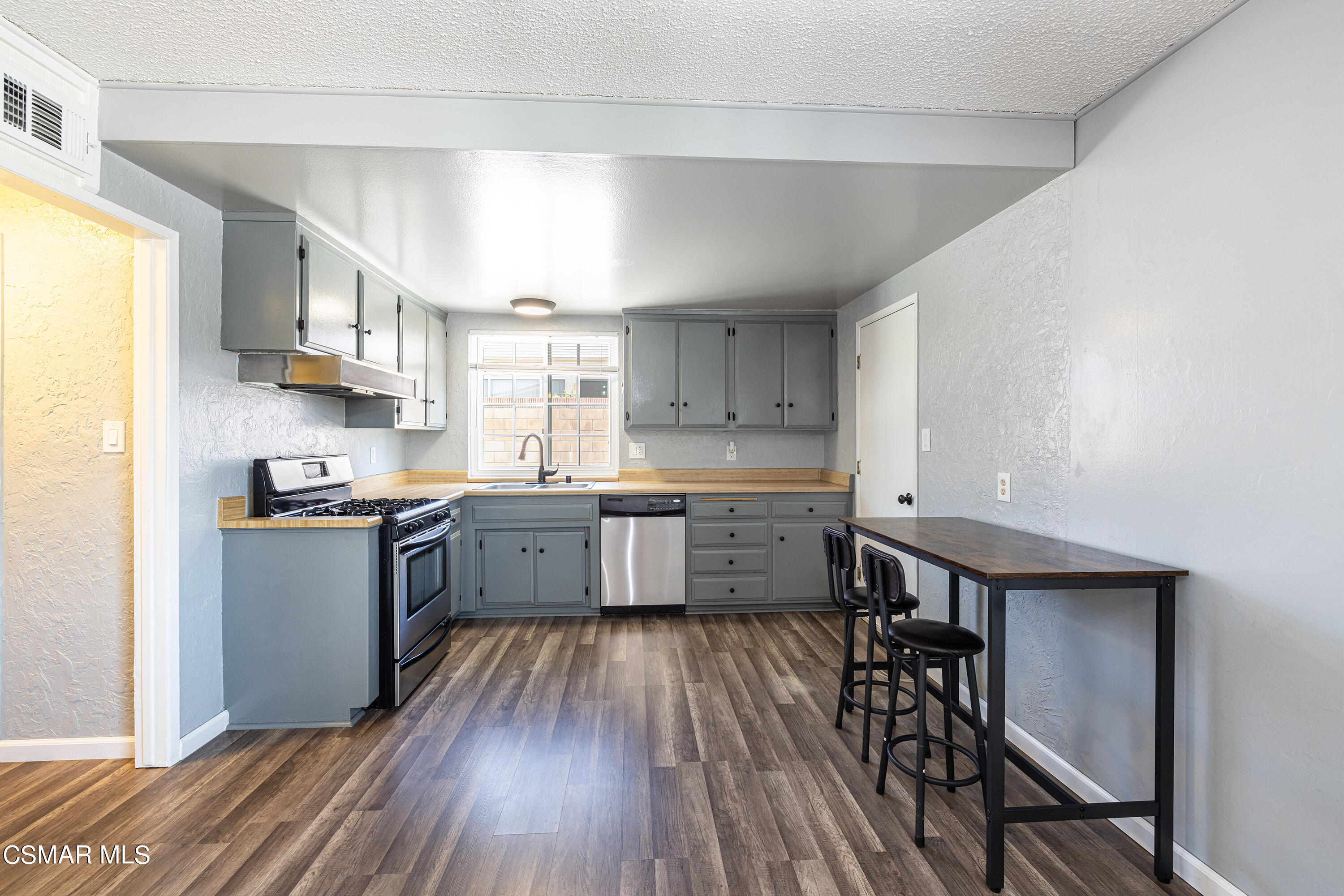 2905 Fitzgerald Road Simi Valley, CA 93065 - Photo 8 of 25 a kitchen with a wooden floor and a window