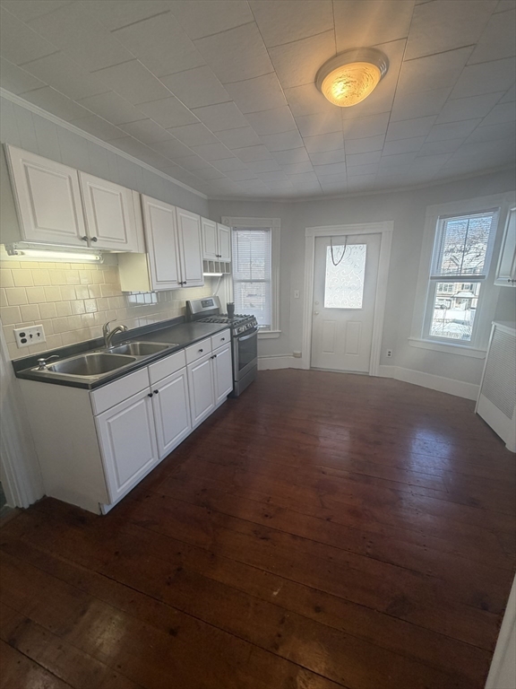 23 Saunders Street, Unit 25F North Andover, MA 01845 - Photo 3 of 12 a kitchen with stainless steel appliances granite countertop a stove a sink and white cabinets with wooden floor