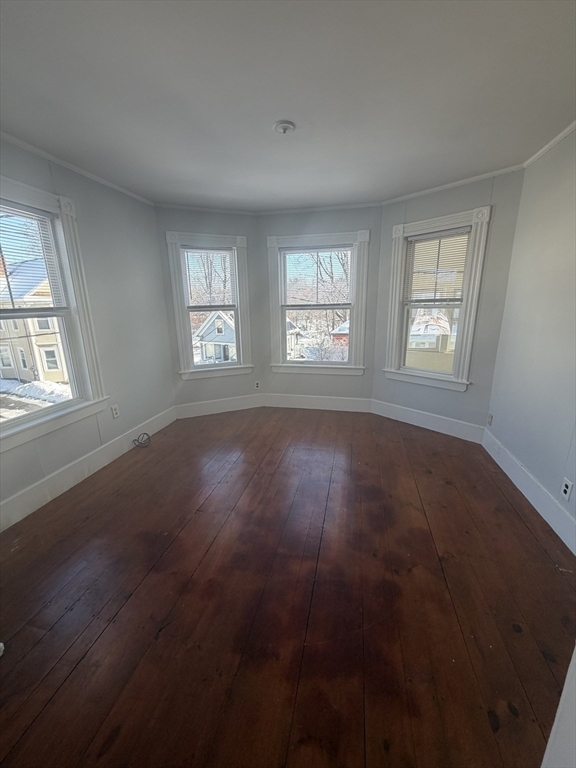 23 Saunders Street, Unit 25F North Andover, MA 01845 - Photo 4 of 12 an empty room with wooden floor and windows