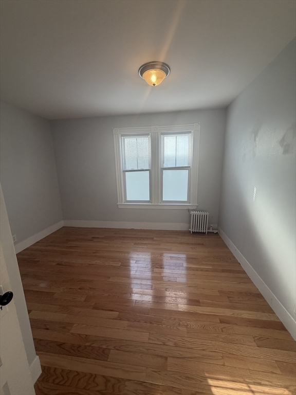 23 Saunders Street, Unit 25F North Andover, MA 01845 - Photo 6 of 12 an empty room with wooden floor and windows
