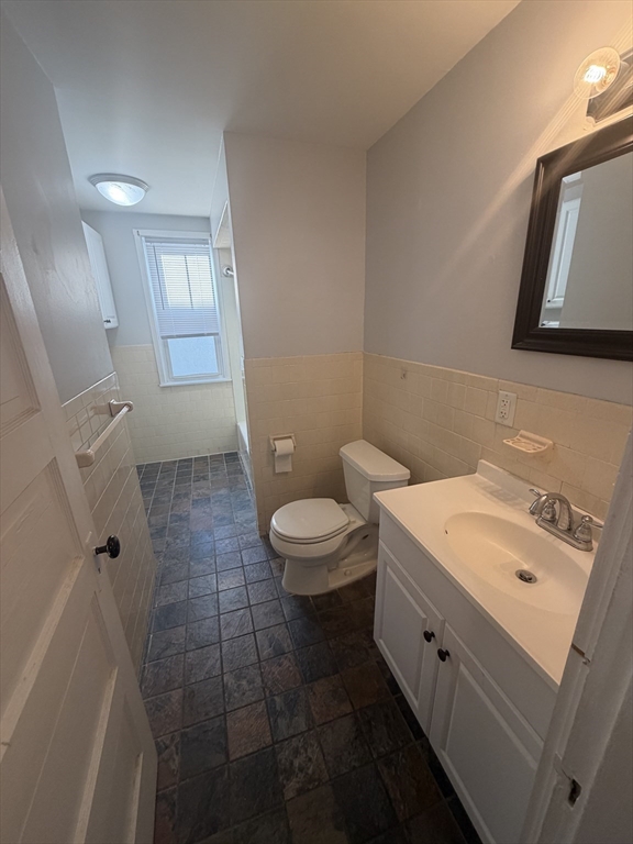 23 Saunders Street, Unit 25F North Andover, MA 01845 - Photo 7 of 12 a bathroom with a sink a toilet and mirror