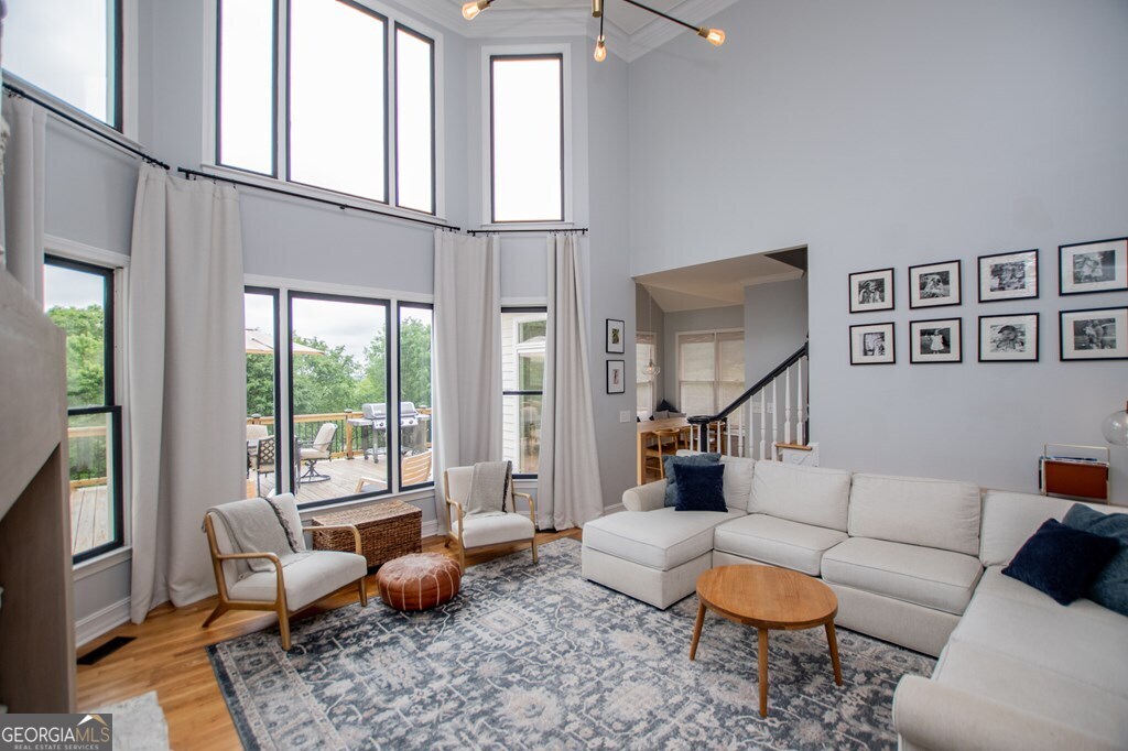 1745 Stripling Chapel Road Carrollton, GA 30116 - Photo 14 of 69 a living room with furniture and a floor to ceiling window
