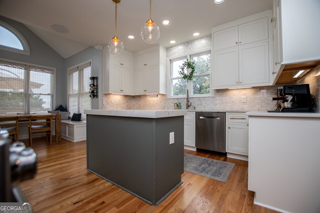 1745 Stripling Chapel Road Carrollton, GA 30116 - Photo 19 of 69 a kitchen with kitchen island granite countertop a sink counter top space and appliances