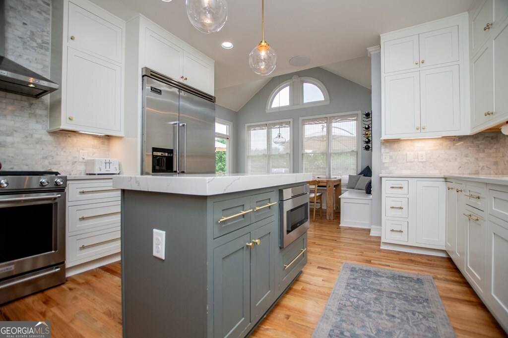1745 Stripling Chapel Road Carrollton, GA 30116 - Photo 20 of 69 a kitchen with stainless steel appliances granite countertop a stove a sink and a microwave
