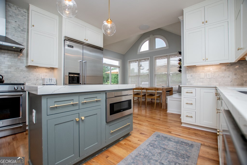 1745 Stripling Chapel Road Carrollton, GA 30116 - Photo 21 of 69 a kitchen with a stove cabinets and a wooden floor