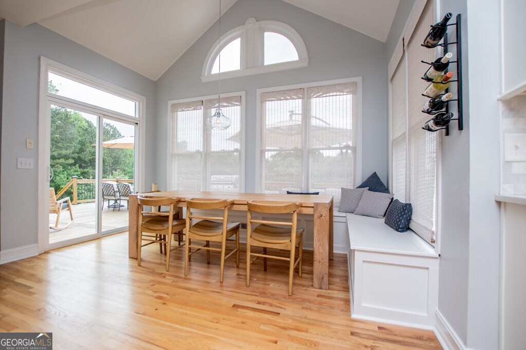1745 Stripling Chapel Road Carrollton, GA 30116 - Photo 26 of 69 a dining room with wooden floor a glass table and chairs