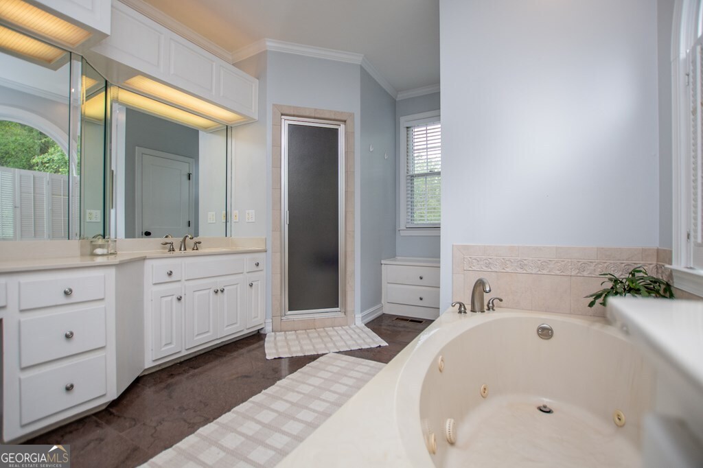 1745 Stripling Chapel Road Carrollton, GA 30116 - Photo 30 of 69 a bathroom with a tub sink and mirror