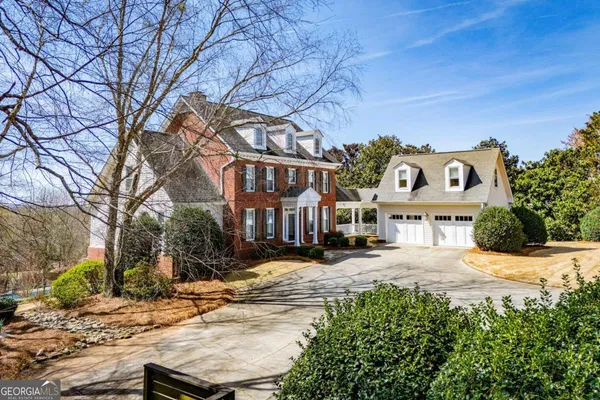a front view of a house with a yard covered with snow in front of house