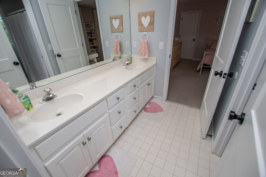 1745 Stripling Chapel Road Carrollton, GA 30116 - Photo 35 of 69 a bathroom with a double vanity sink mirror and shower