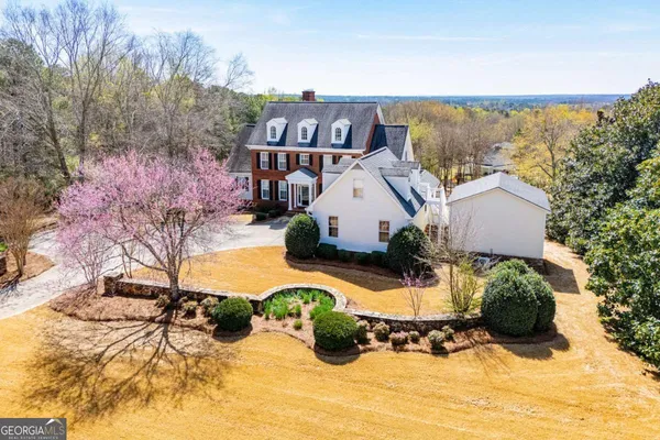a view of a house with a yard covered in snow