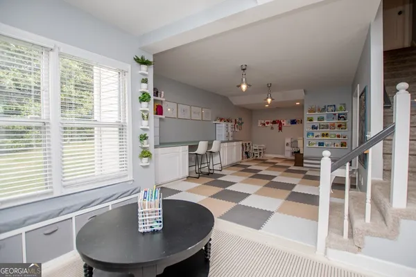 a view of a fountain in front of a house with a big yard