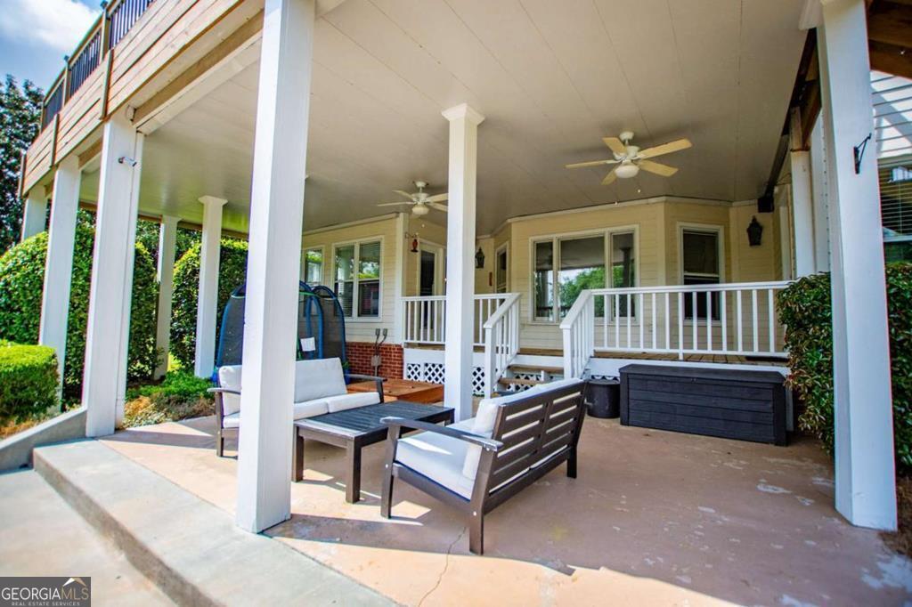 1745 Stripling Chapel Road Carrollton, GA 30116 - Photo 66 of 69 a outdoor space with patio the couches and a dining table with garden view