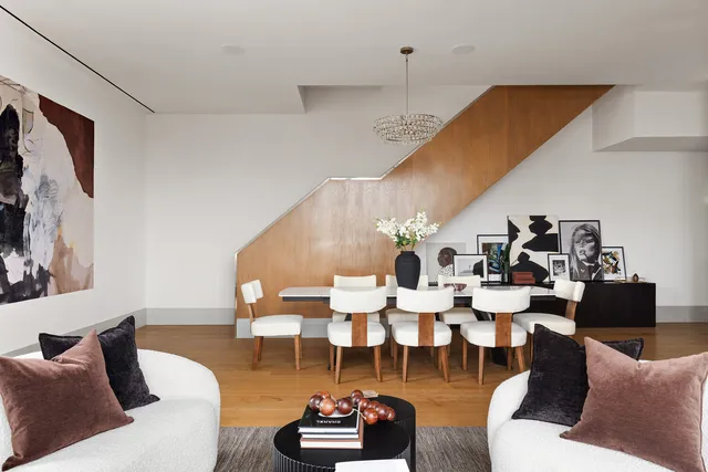 a living room with lots of furniture and a painting