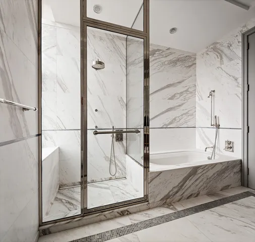 a bathroom with a bathtub and a shower