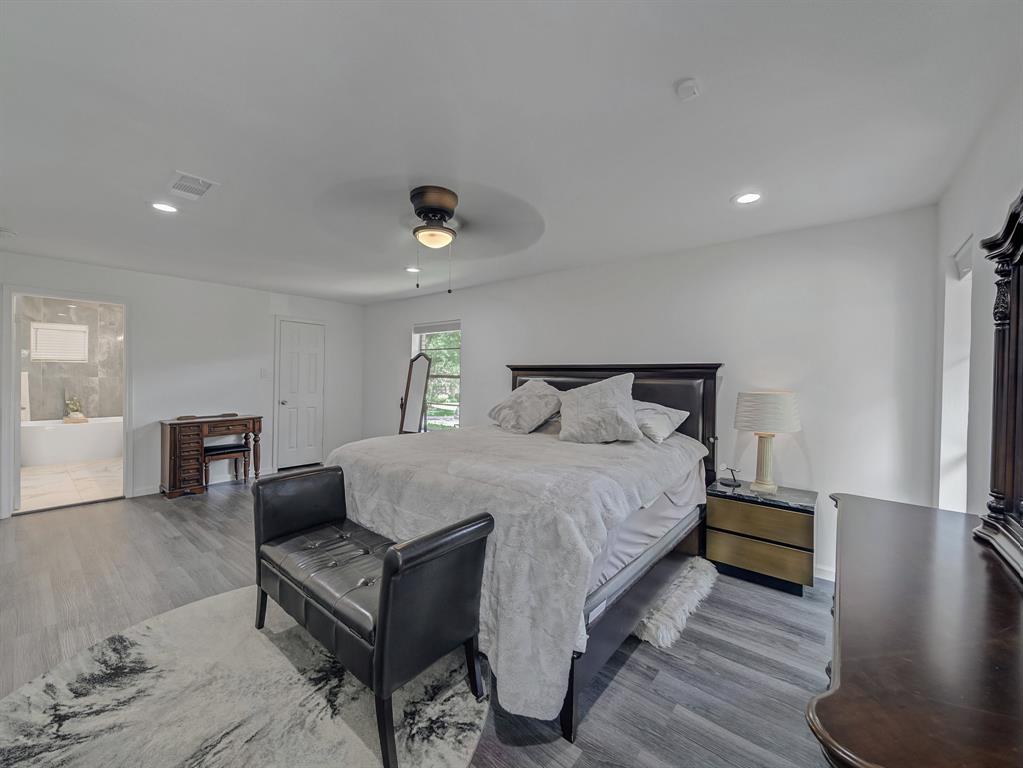 4606 Hazelhurst Lane Dallas, TX 75227 - Photo 11 of 30 a bedroom with a bed and a couch