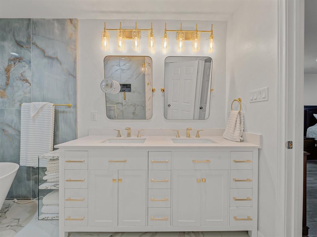 4606 Hazelhurst Lane Dallas, TX 75227 - Photo 13 of 30 a bathroom with a double vanity sink mirror and