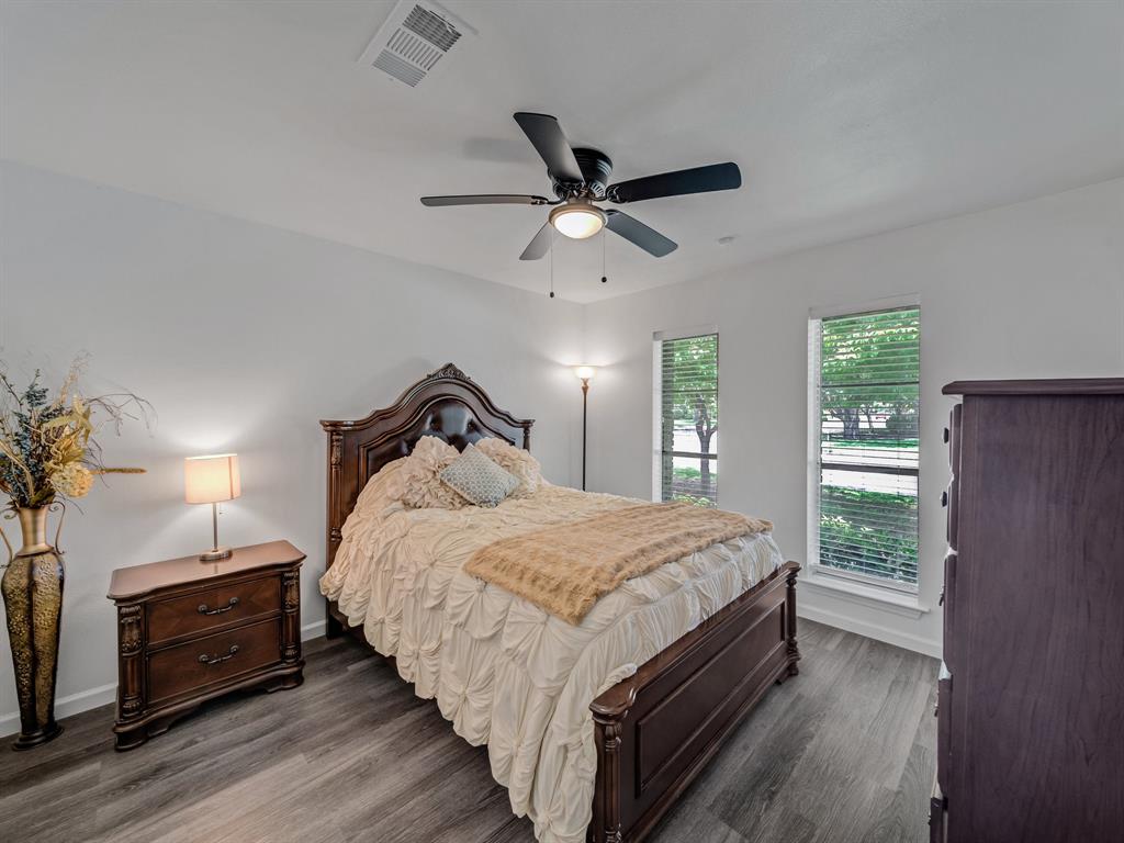 4606 Hazelhurst Lane Dallas, TX 75227 - Photo 18 of 30 a bedroom with bed and wooden floor