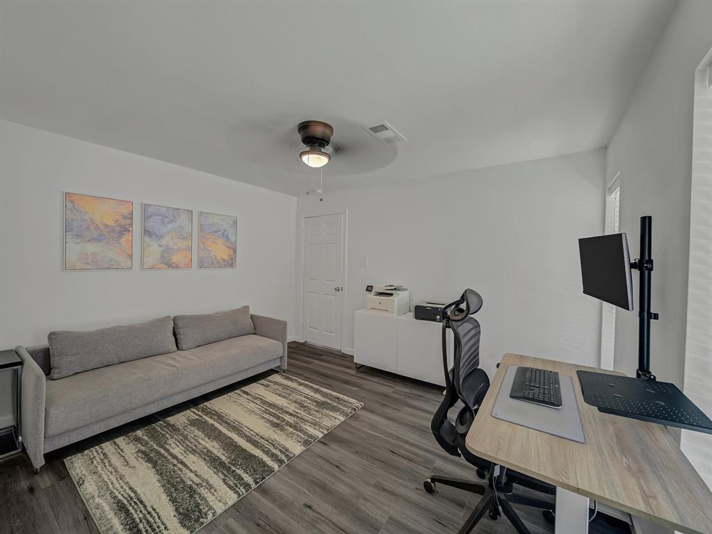4606 Hazelhurst Lane Dallas, TX 75227 - Photo 21 of 30 a living room with furniture and a flat screen tv