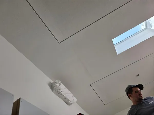 a utility room with stainless steel appliances wooden cabinets a stove a sink and a refrigerator