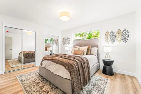 a bedroom with a large bed and a chandelier