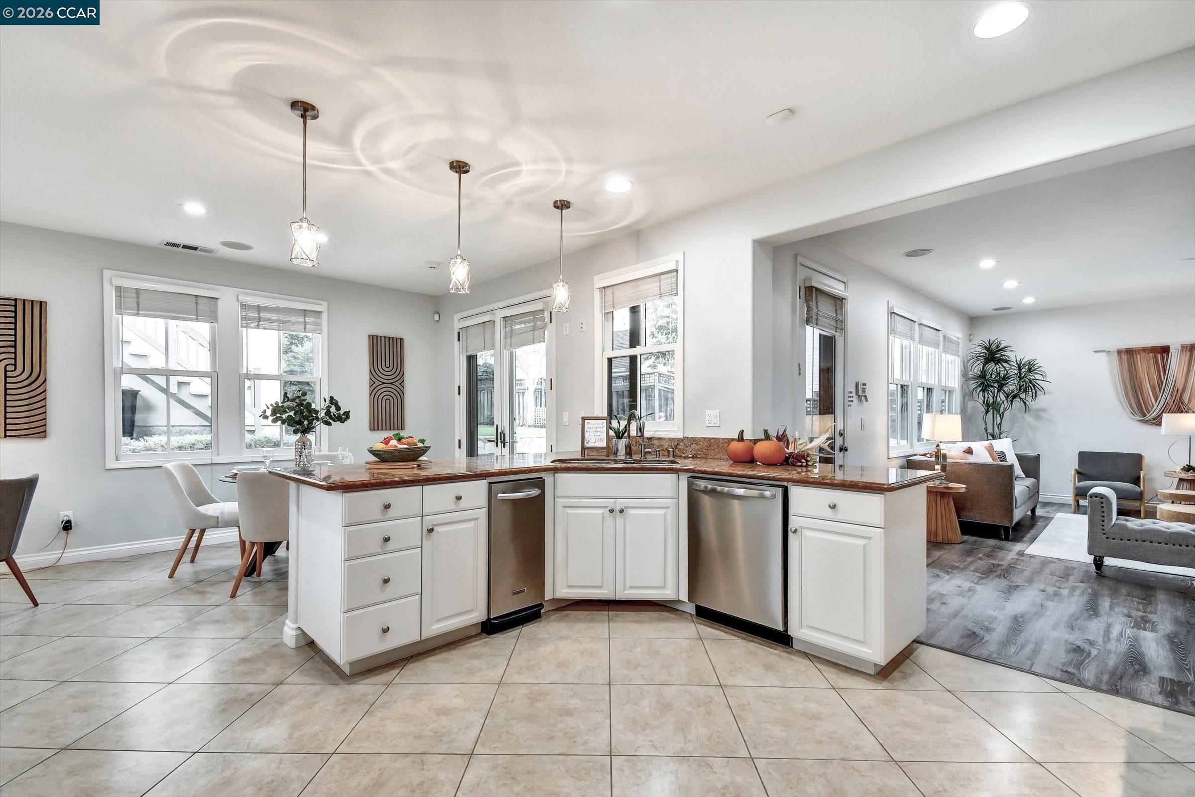 1018 Promenade Street Hercules, CA 94547 - Photo 21 of 60 a large kitchen with kitchen island a sink a counter top space and appliances