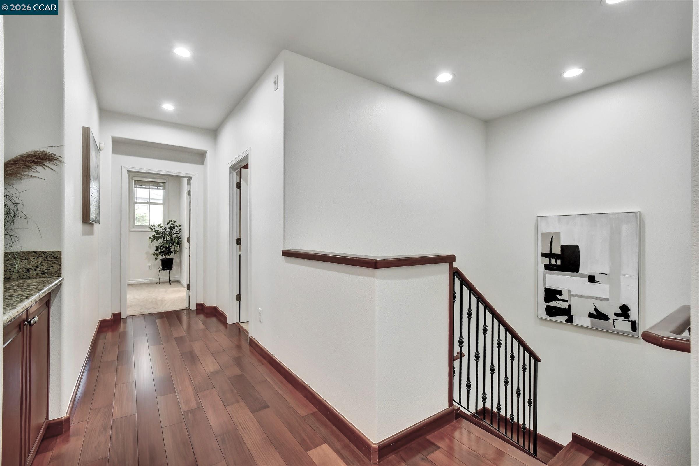 1018 Promenade Street Hercules, CA 94547 - Photo 32 of 60 a view of a hallway with wooden floor and stairs