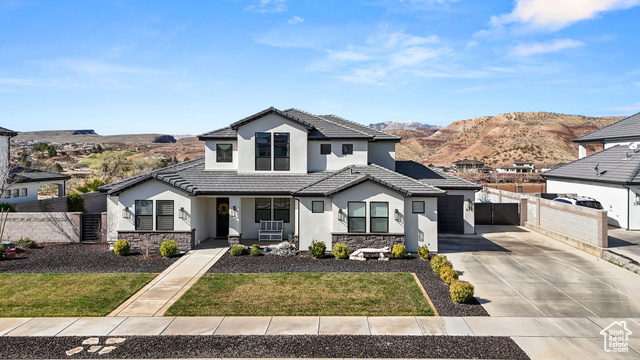 Modern inspired farmhouse featuring stone siding, fence, and stucco siding
