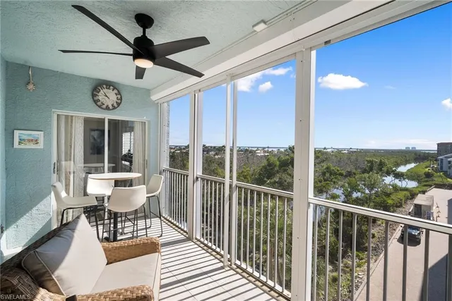 a view of a very nice looking dining room with furniture window and ceiling fan