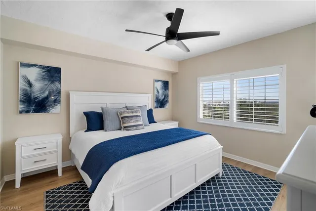 a bedroom with a bed and a lamp on a dresser