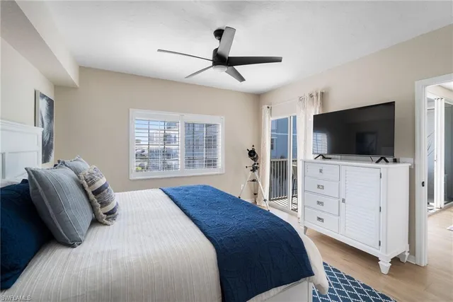 a living room with furniture a ceiling fan and a rug