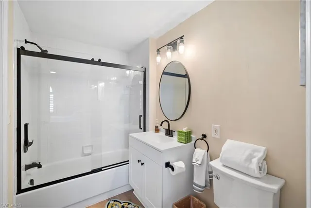 a bathroom with a toilet a sink and a mirror