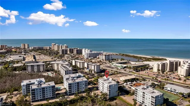 a view of swimming pool with outdoor seating and house in the background