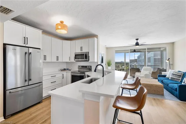 a kitchen with a sink stove and microwave