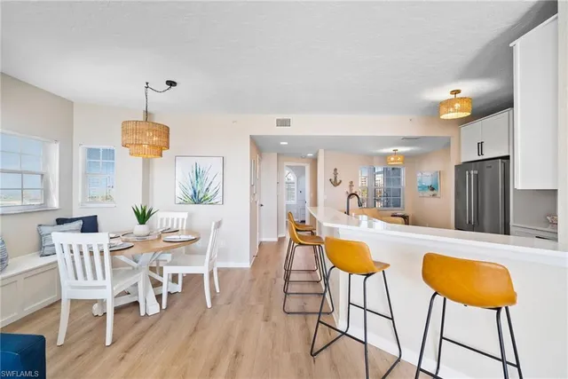 a dining room with furniture and wooden floor