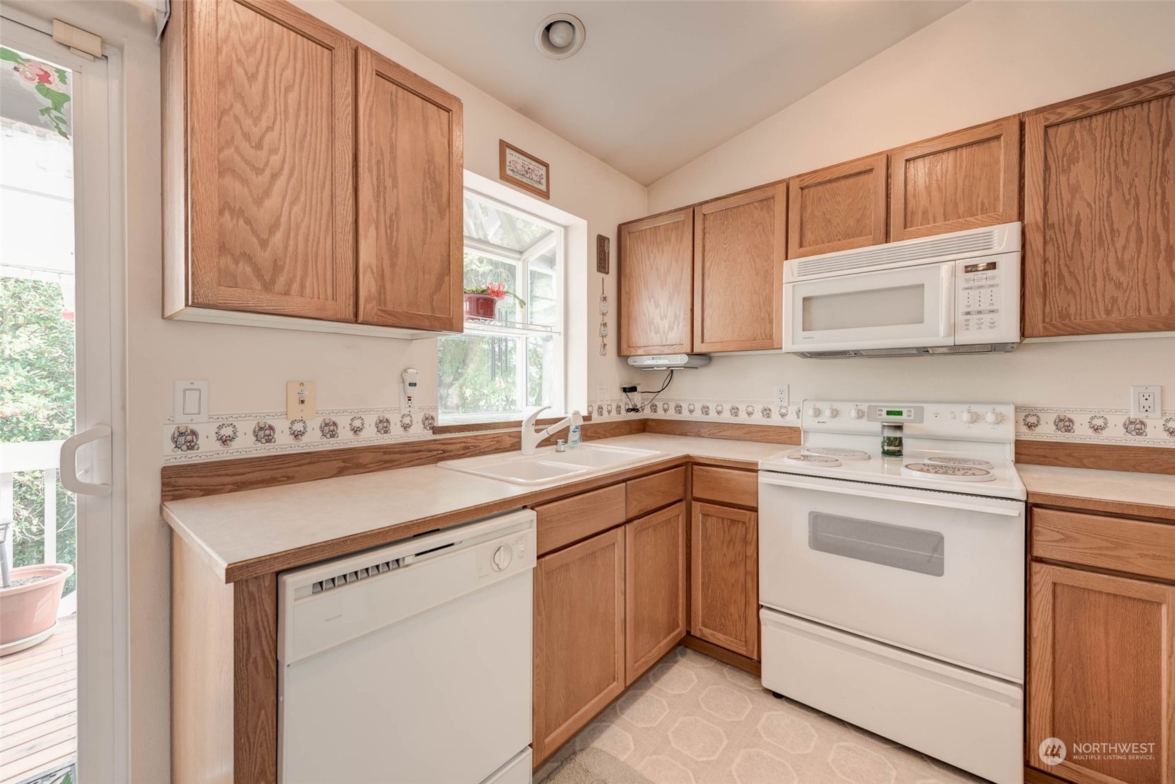 225 99th Place Southwest Everett, WA 98204 - Photo 5 of 30 a kitchen with cabinets appliances a sink and a window