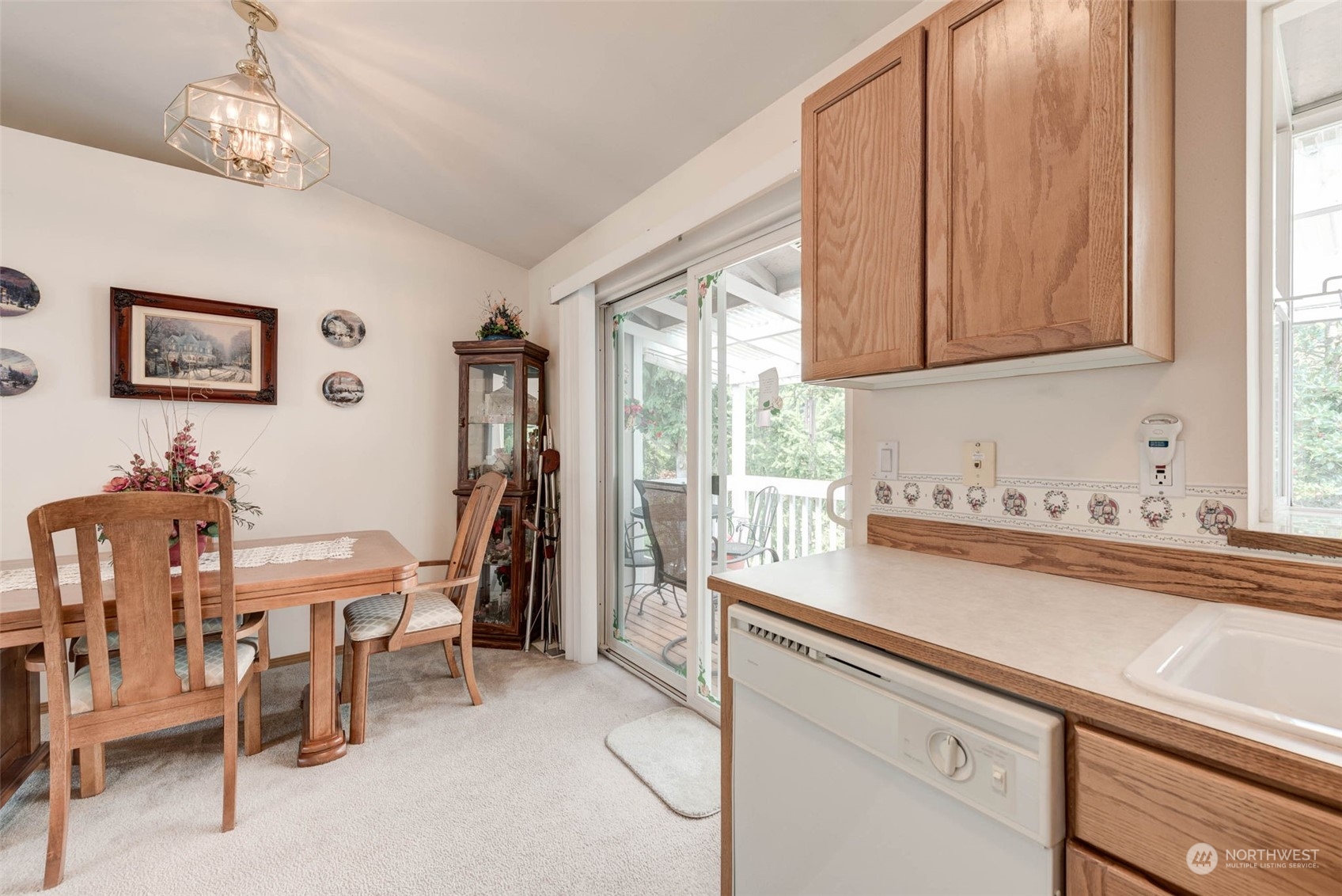 225 99th Place Southwest Everett, WA 98204 - Photo 7 of 30 a kitchen with stainless steel appliances a table and chairs in it