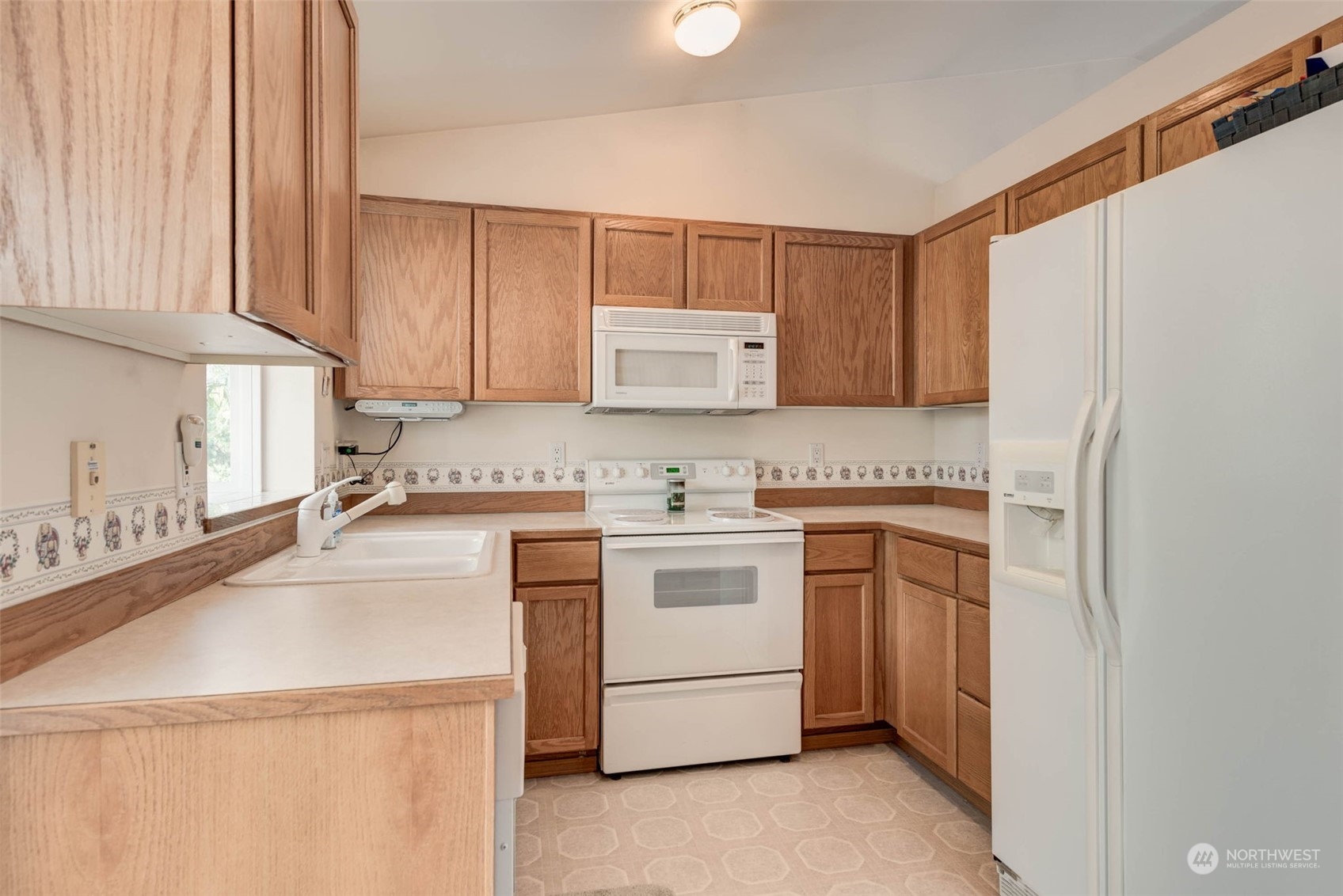 225 99th Place Southwest Everett, WA 98204 - Photo 8 of 30 a kitchen with a stove sink and cabinets