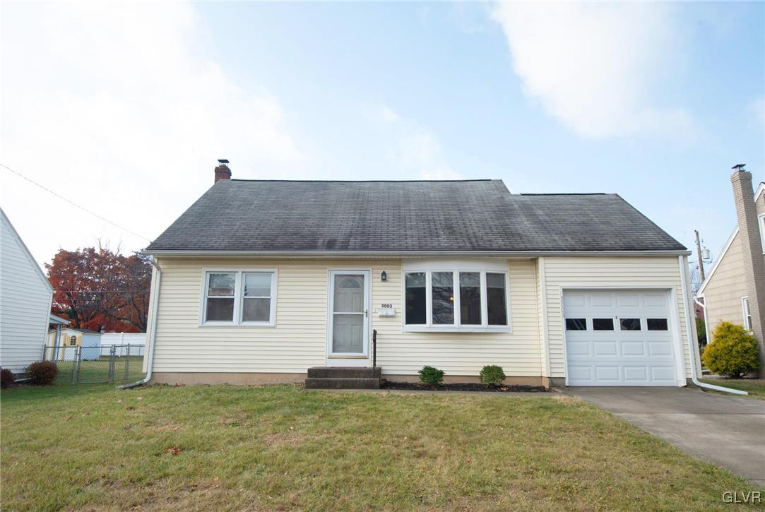 a house that has a big yard with wooden fence