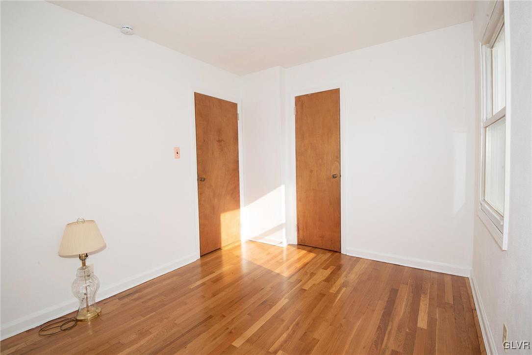 3003 Cornwall Road Bethlehem, PA 18017 - Photo 15 of 27 a view of an empty room with wooden floor and a window